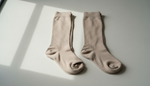Open-toe and closed-toe compression stockings displayed side by side for comparison