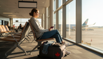Traveller at an airport gate with folded compression socks packed in a carry-on bag