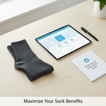A professional flat lay showing medical-grade compression socks, a laptop with a health benefits portal, and documents, symbolizing how to maximize extended health benefits for compression socks in Canada. Clean, modern aesthetic.