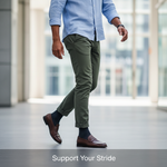 A man in smart-casual attire taking a confident stride, subtly revealing men's compression hose, in a bright, modern setting. Illustrates benefits, levels, and fit of compression hose in Canada.