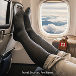 A person's legs, wearing stylish knee-high compression socks, relaxed in an airplane seat with a view of clouds. The image promotes top compression socks for travel, preventing swelling and DVT for jetsetters.
